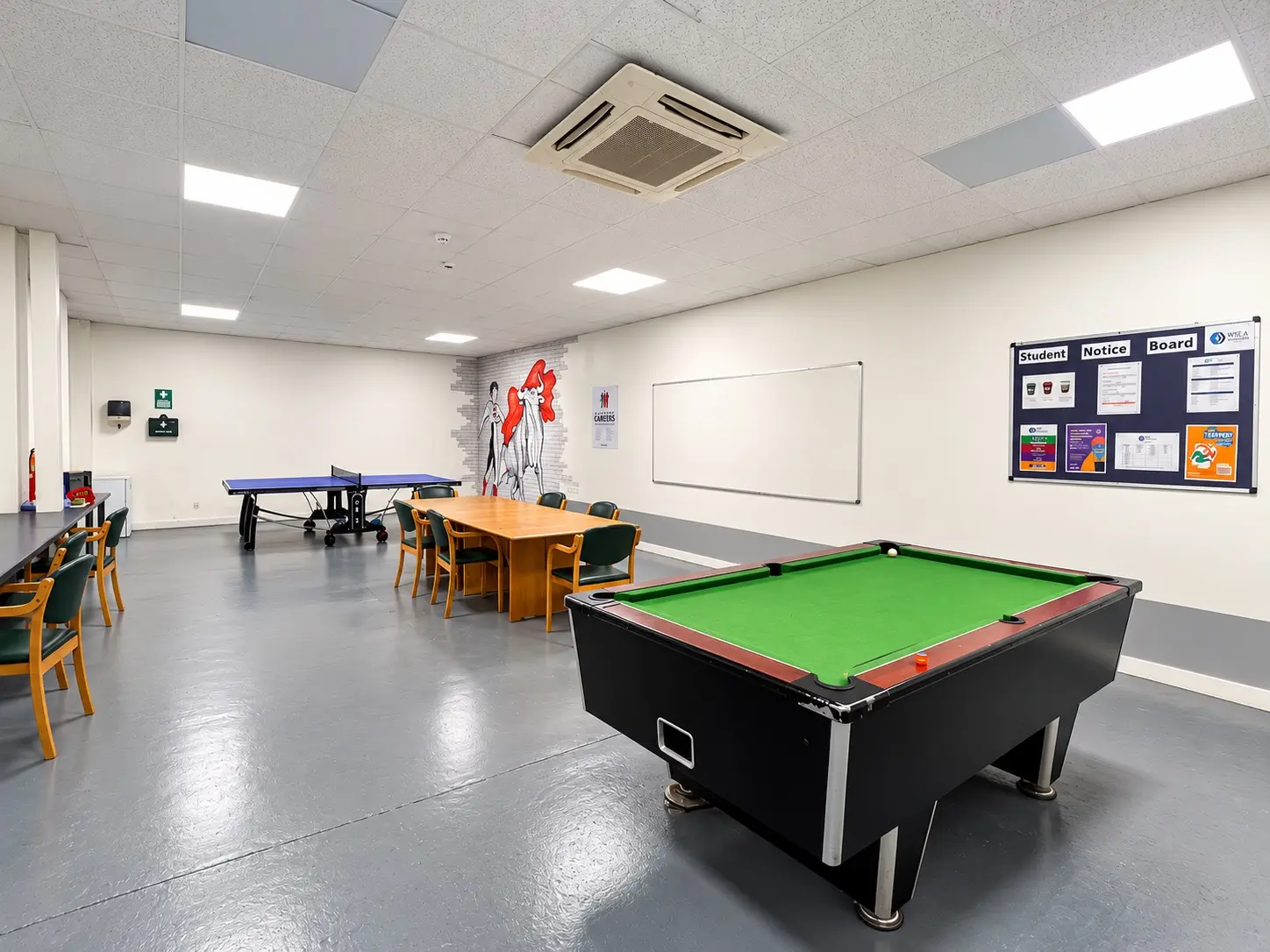 The Waterfront social space, with a pool table, table tennis, seating and a student notice board
